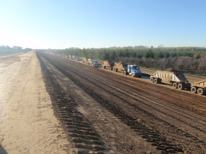 trucks hauling dirt