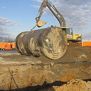 crane moving large cylinder